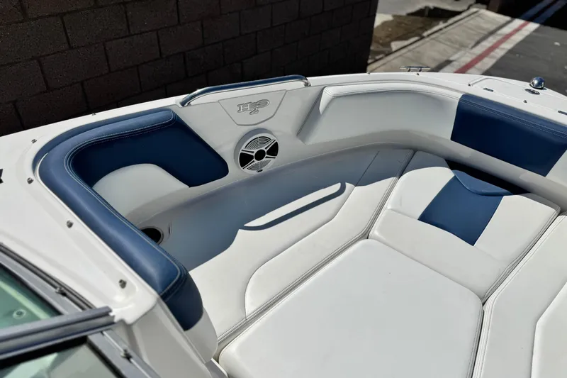 Slide: The Image of 2014 Chaparral 21 H2O Sport boat interior with blue and white seating. - 10