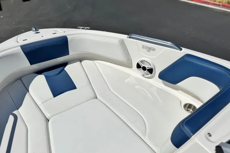 Slide: The Image of 2014 Chaparral 21 H2O Sport boat interior with blue and white seating. - 11