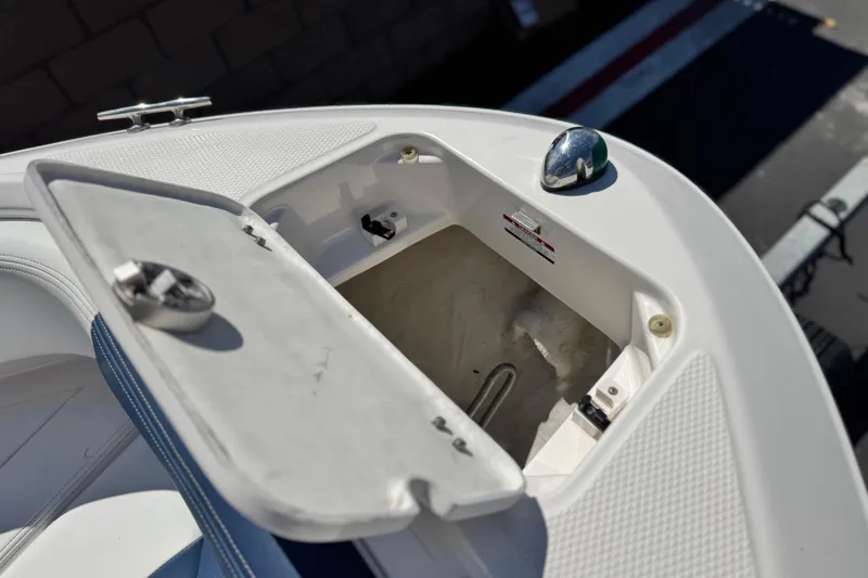 Slide: The Image of Open storage compartment on 2014 Chaparral 21 H2O Sport boat, showing interior details. - 13