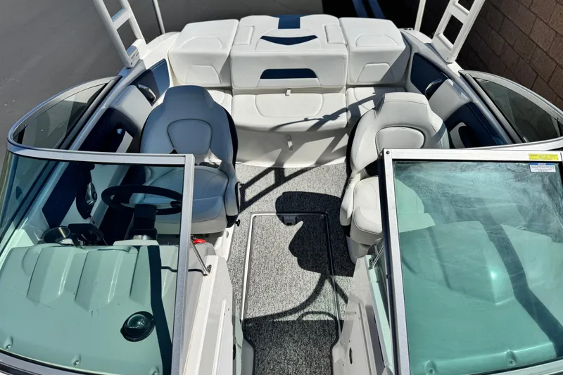 Slide: The Image of 2014 Chaparral 21 H2O Sport boat interior with seating and steering wheel. - 14