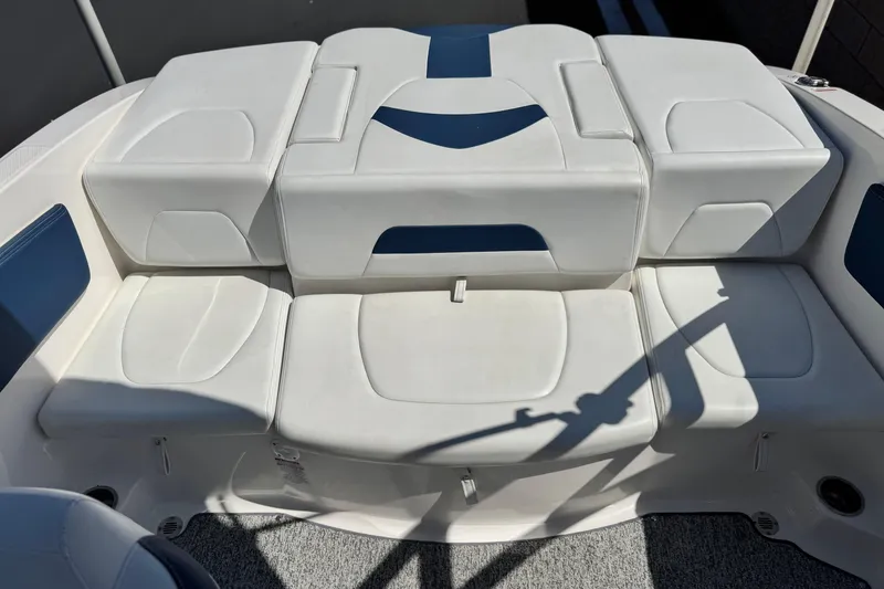Slide: The Image of 2014 Chaparral 21 H2O Sport boat interior with white cushioned seating. - 15