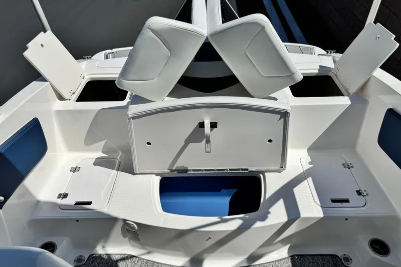 Slide: The Image of 2014 Chaparral 21 H2O Sport boat interior with open storage compartments. - 16