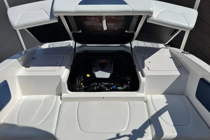 Slide: The Image of 2014 Chaparral 21 H2O Sport boat engine compartment with open hatches. - 17