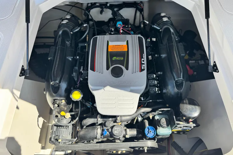 Slide: The Image of Engine compartment of a 2014 Chaparral 21 H2O Sport boat, featuring a MerCruiser 5.0 MPI engine. - 18