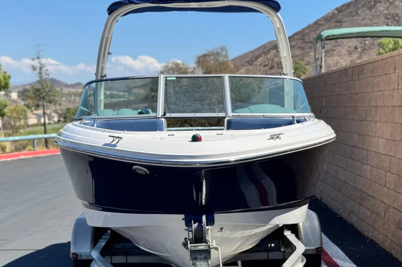 Slide: The Image of 2014 Chaparral 21 H2O Sport boat on trailer, parked outdoors. - 2