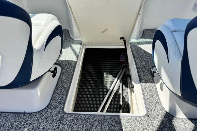 Slide: The Image of 2014 Chaparral 21 H2O Sport boat interior with open storage compartment. - 20