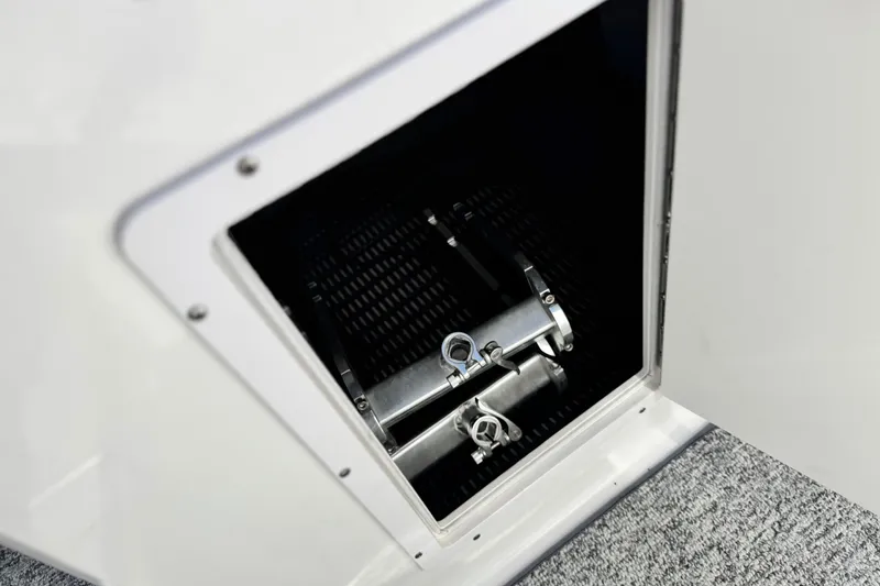 Slide: The Image of Storage compartment of 2014 Chaparral 21 H2O Sport boat, featuring secure metal latches. - 23