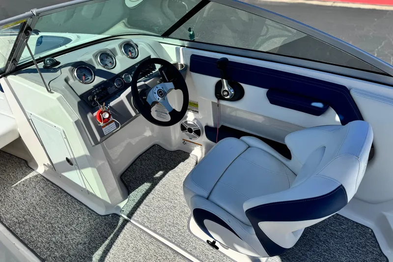 Slide: The Image of 2014 Chaparral 21 H2O Sport boat interior with steering wheel and dashboard controls. - 24