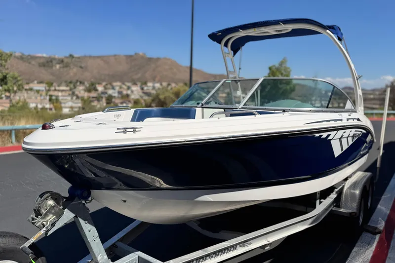 Slide: The Image of 2014 Chaparral 21 H2O Sport boat on trailer, scenic background. - 3