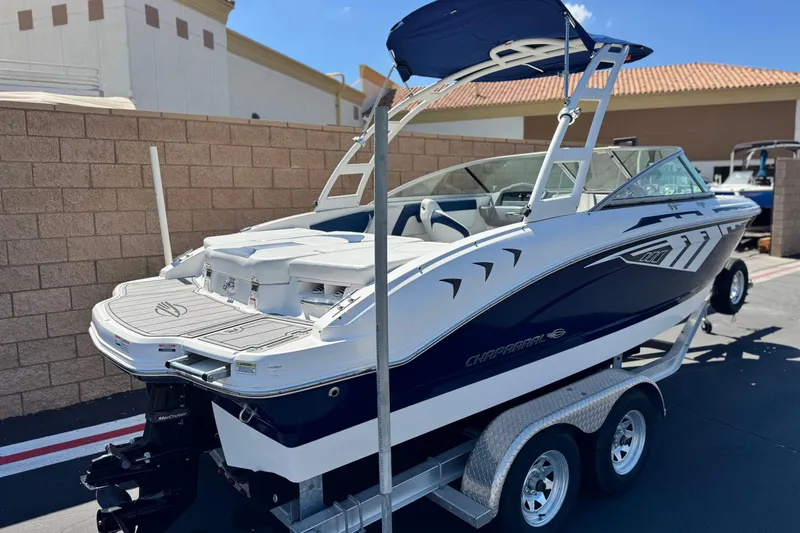 Slide: The Image of 2014 Chaparral 21 H2O Sport boat on trailer, parked outdoors. - 5