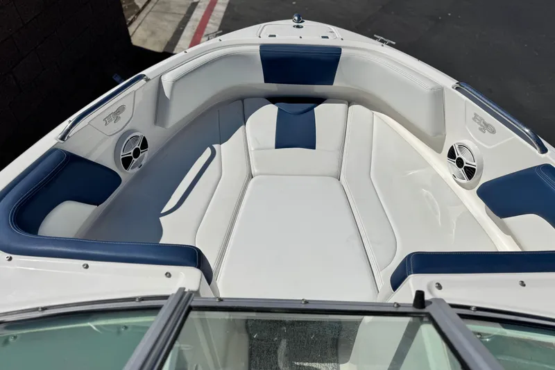 Slide: The Image of 2014 Chaparral 21 H2O Sport boat interior with blue and white seating. - 9