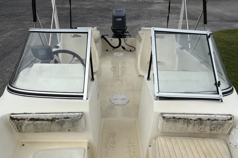 Slide: The Image of 1996 Key West 1720 Dual Console boat interior with open windshield and visible steering wheel. - 12