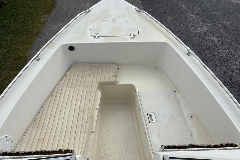 Slide: The Image of 1996 Key West 1720 Dual Console boat interior with seating and storage compartments. - 13