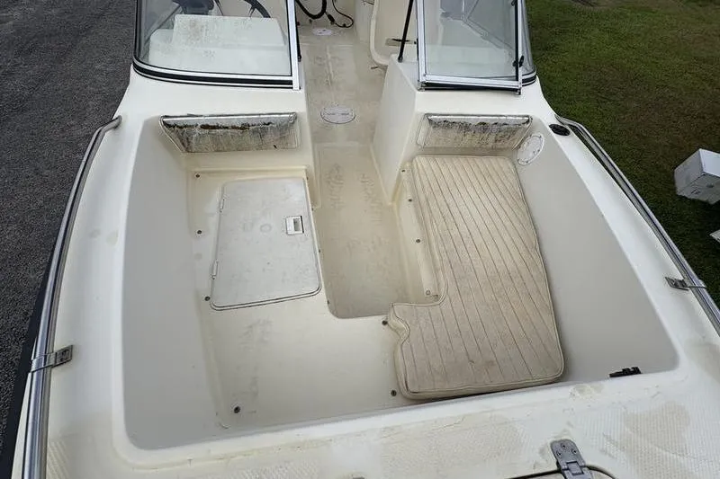 Slide: The Image of 1996 Key West 1720 Dual Console boat interior with seating and storage compartments. - 15
