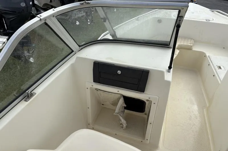 Slide: The Image of 1996 Key West 1720 Dual Console boat interior with windshield and storage compartment. - 3