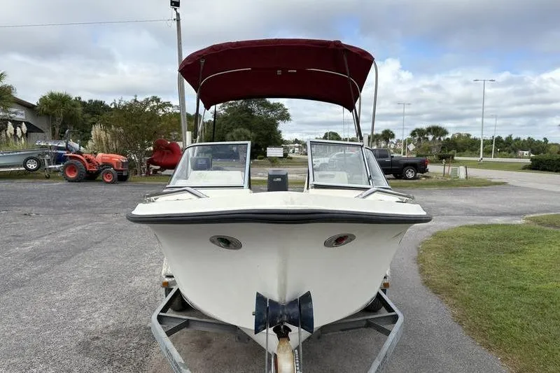Slide: The Image of 1996 Key West 1720 Dual Console boat with red canopy on trailer. - 4