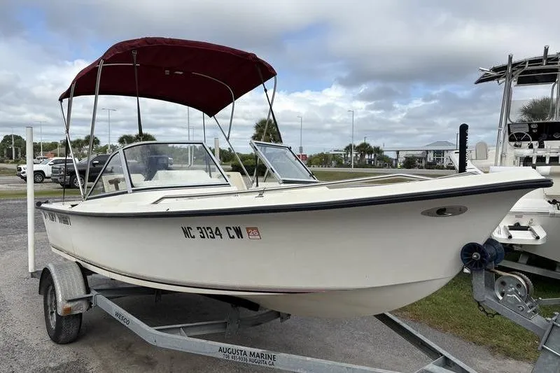 Slide: The Image of 1996 Key West 1720 Dual Console boat on trailer with red canopy. - 5