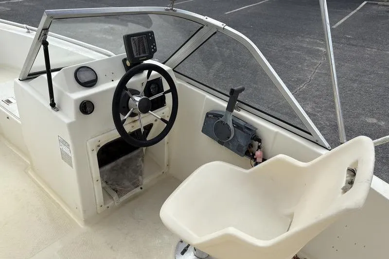 Slide: The Image of 1996 Key West 1720 Dual Console boat interior with steering wheel and seat. - 7