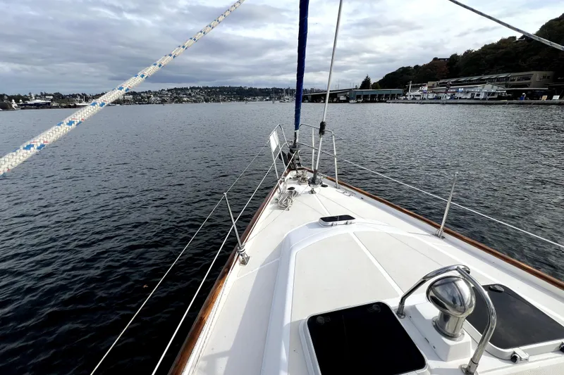 Slide: The Image of Sailing on a 1989 Taswell 43 yacht, overlooking calm waters and distant shoreline. - 10