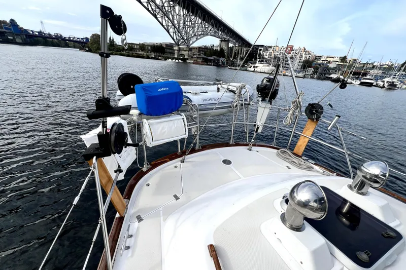 Slide: The Image of 1989 Taswell 43 sailboat deck view with marina and bridge in the background. - 12