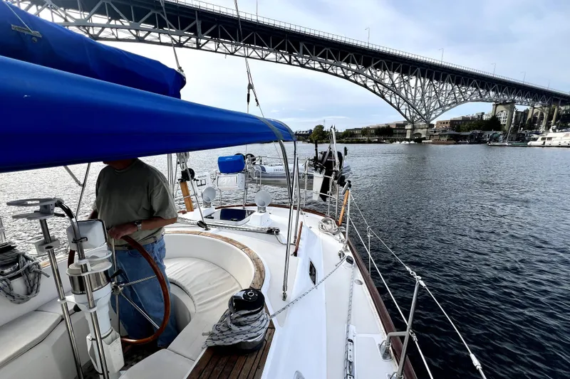 Slide: The Image of Sailing on a 1989 Taswell 43 yacht under a large bridge on a calm river. - 18
