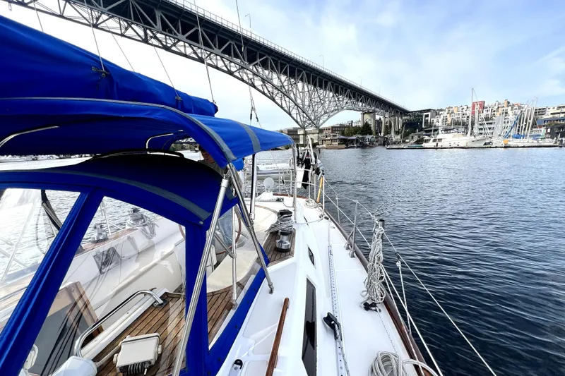 Slide: The Image of Sailboat Taswell 43 (1989) cruising under a bridge in a scenic marina setting. - 20