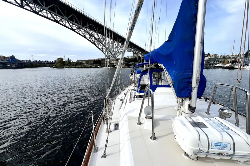 Slide: The Image of Sailboat Taswell 43 (1989) cruising under a bridge on a calm waterway. - 22