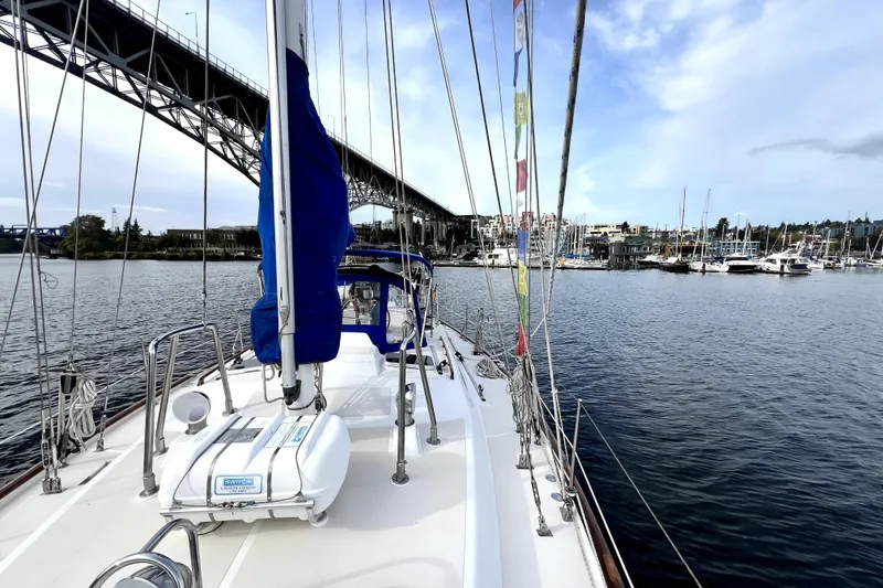 Slide: The Image of Sailing on a 1989 Taswell 43 yacht under a bridge near a marina. - 23