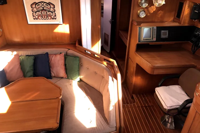 Slide: The Image of Interior of 1989 Taswell 43 yacht with cozy seating and navigation area. - 24