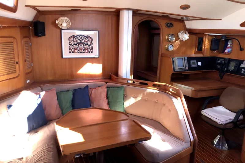 Slide: The Image of Interior of 1989 Taswell 43 yacht with cozy seating and navigation area. - 25