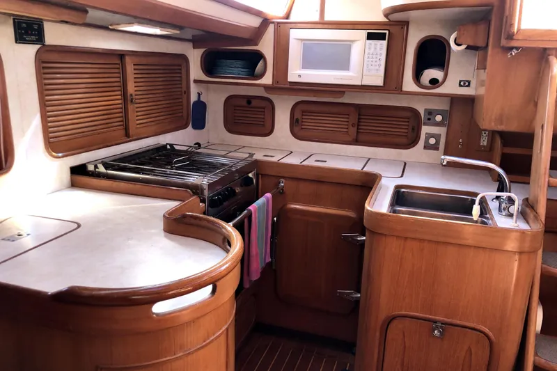Slide: The Image of Interior of 1989 Taswell 43 yacht kitchen with wooden cabinetry and modern appliances. - 28