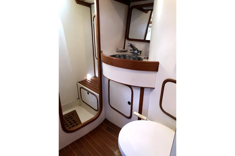 Slide: The Image of 1989 Taswell 43 yacht bathroom with wooden accents and compact design. - 33