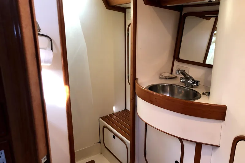 Slide: The Image of 1989 Taswell 43 yacht bathroom with sink, mirror, and wooden accents. - 37