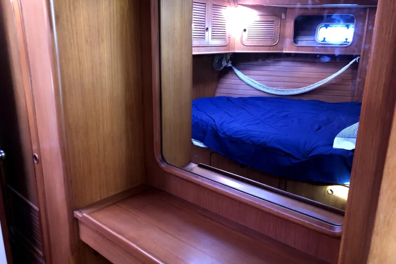 Slide: The Image of Cozy cabin interior of 1989 Taswell 43 sailboat with wooden finish and blue bedding. - 39