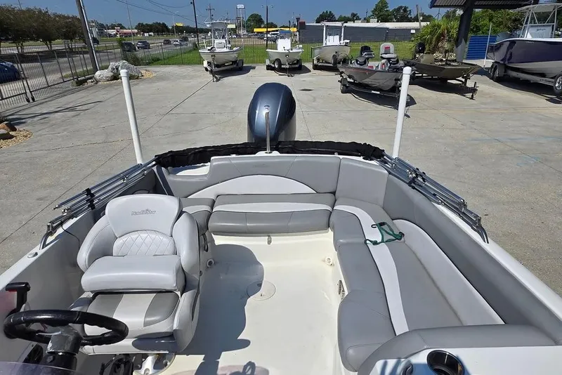 Slide: The Image of 2021 NauticStar 203 SE boat interior with gray seating and steering wheel. - 10