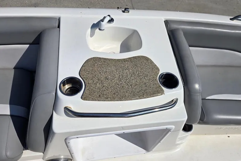 Slide: The Image of 2021 NauticStar 203 SE boat interior with sink, cup holders, and seating. - 13