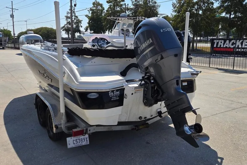 Slide: The Image of 2021 NauticStar 203 SE boat with Yamaha outboard motor, parked at a marina. - 5