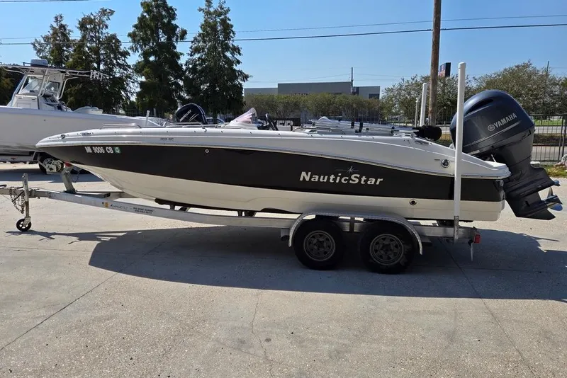 Slide: The Image of 2021 NauticStar 203 SE boat with Yamaha outboard motor on a trailer. - 6