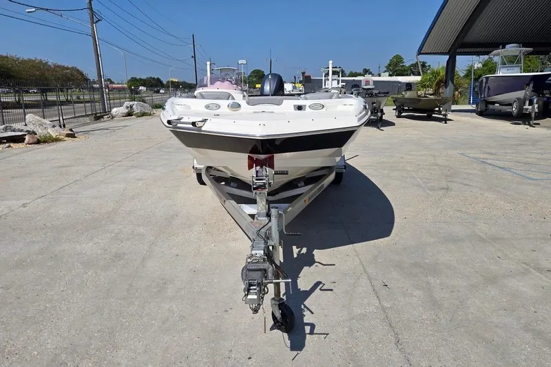 Slide: The Image of 2021 NauticStar 203 SE boat with outboard motor, viewed from the rear on a concrete surface. - 7