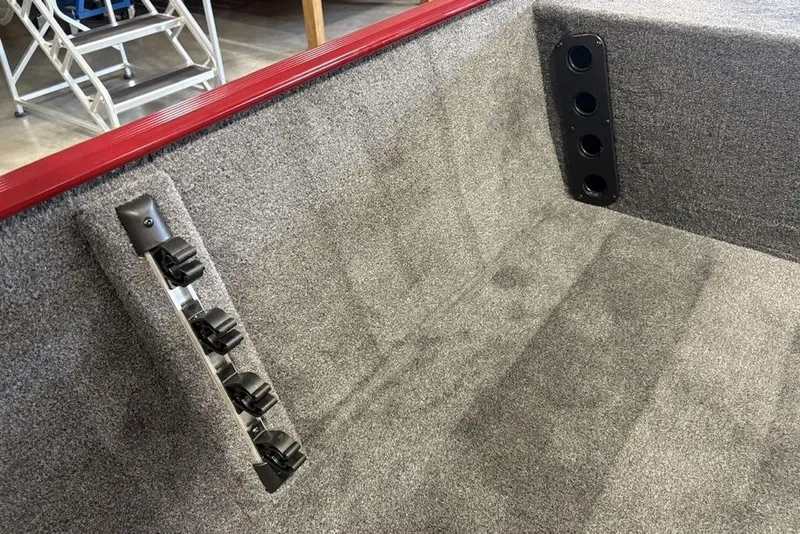 Slide: The Image of 2026 Tracker Bass Tracker Classic XL interior with gray carpet and rod holders. - 15