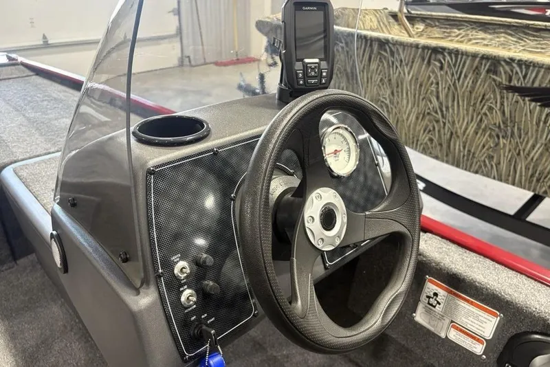 Slide: The Image of 2026 Tracker Bass Tracker Classic XL boat dashboard with steering wheel and Garmin device. - 9