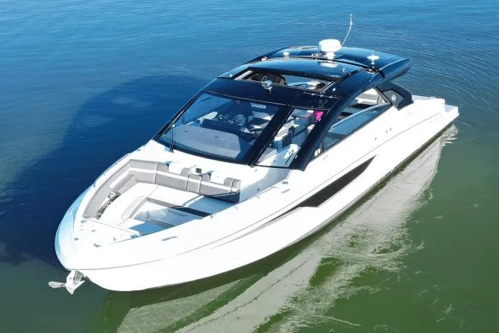 The Image of 2022 Cruisers 42 GLS luxury boat on calm water, showcasing sleek design and modern features. - 0