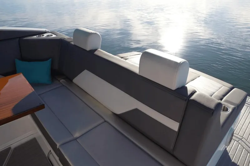 Slide: The Image of Luxurious seating on 2022 Cruisers 42 GLS yacht with sunlit water view. - 15