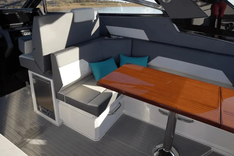 Slide: The Image of 2022 Cruisers 42 GLS yacht interior with seating and wooden table. - 17
