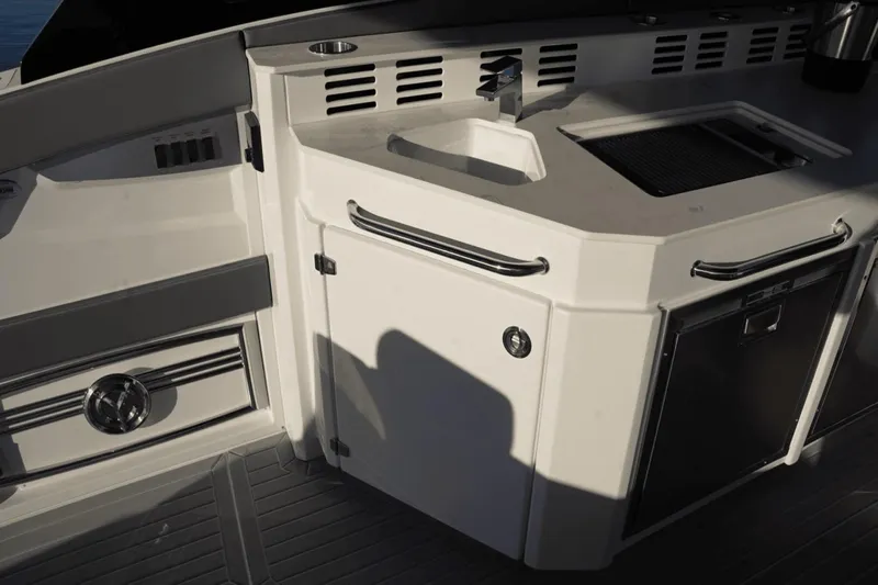 Slide: The Image of Outdoor kitchen area on 2022 Cruisers 42 GLS yacht with sink and grill. - 19