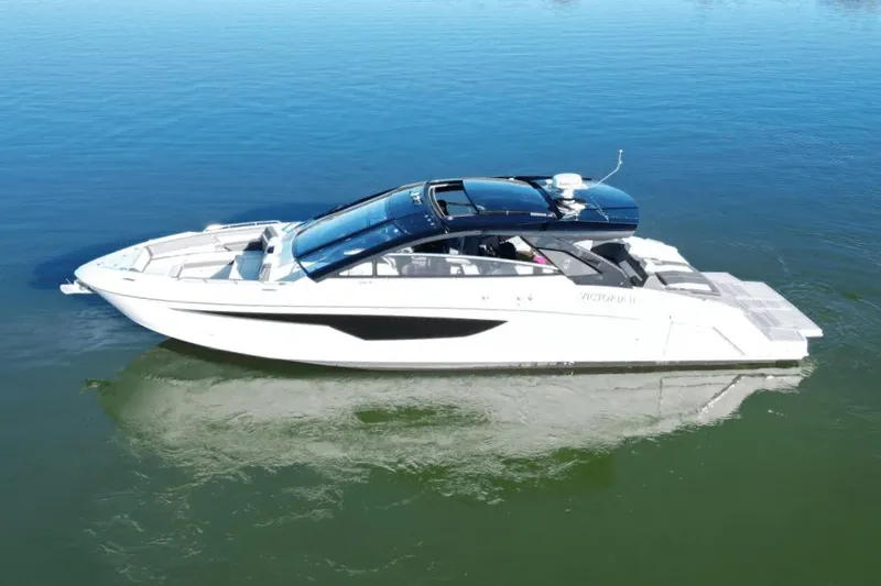 Slide: The Image of 2022 Cruisers 42 GLS luxury yacht on calm water, side view. - 2