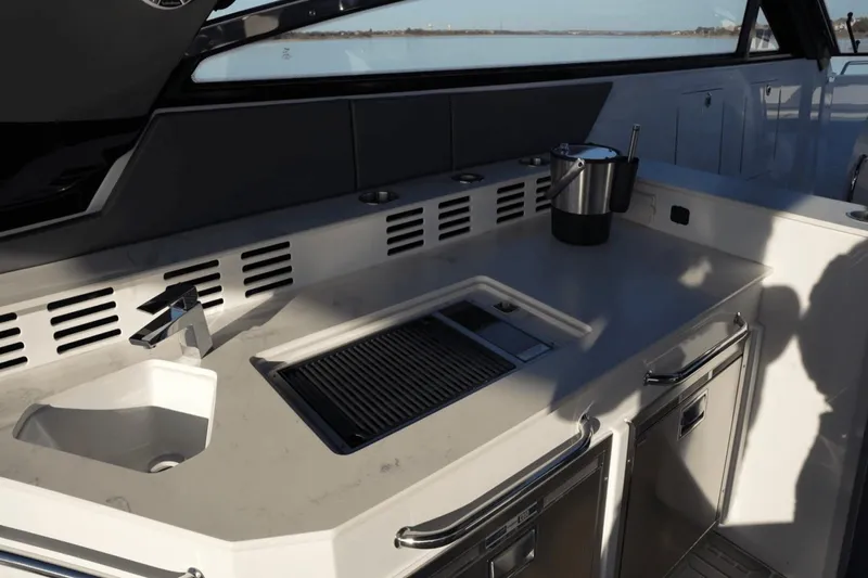 Slide: The Image of 2022 Cruisers 42 GLS yacht kitchenette with sink, grill, and storage. - 20