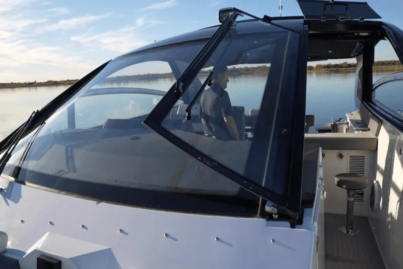 Slide: The Image of 2022 Cruisers 42 GLS yacht with sleek design and spacious cockpit on calm water. - 22