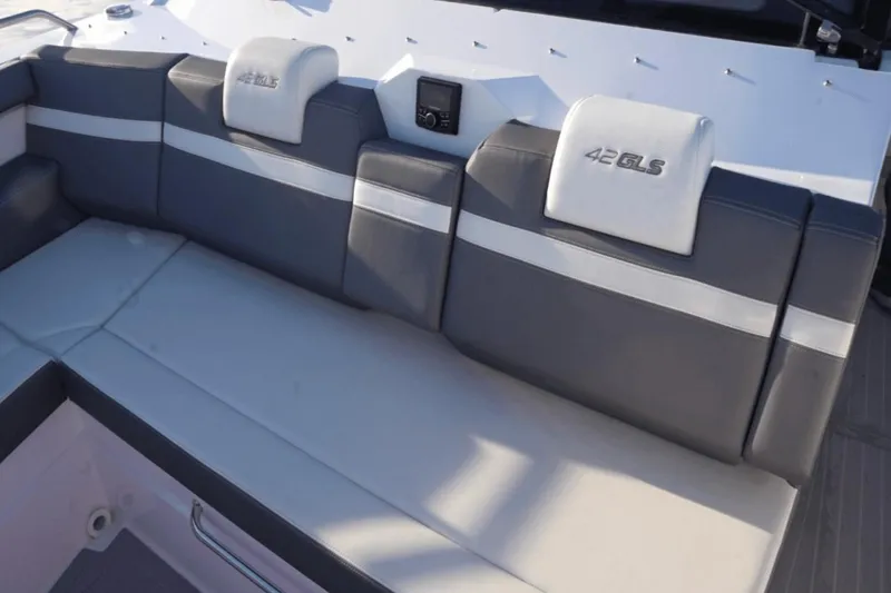 Slide: The Image of 2022 Cruisers 42 GLS boat interior with gray and white cushioned seating. - 24