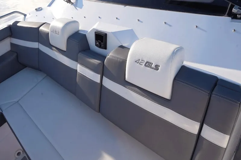 Slide: The Image of Luxury seating on 2022 Cruisers 42 GLS boat, featuring sleek gray and white upholstery. - 25